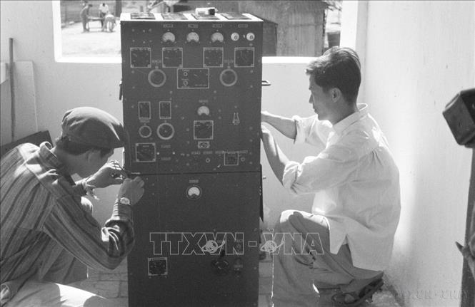 Nhân viên kỹ thuật của Thông tấn xã Việt Nam và Đài phát thanh Việt Nam lắp máy cho đài phát thanh ở Xiêng - Khoảng (Lào). Ảnh: TTXVN